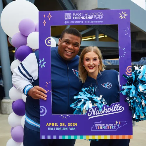 Two people pose together in a handheld frame