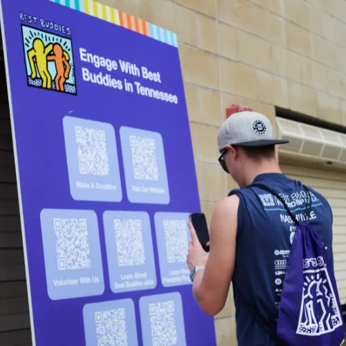 Man scans QR code on a poster
