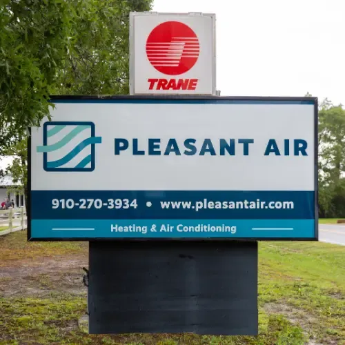 Large outdoor light-up sign displaying Pleasant Air HVAC logo