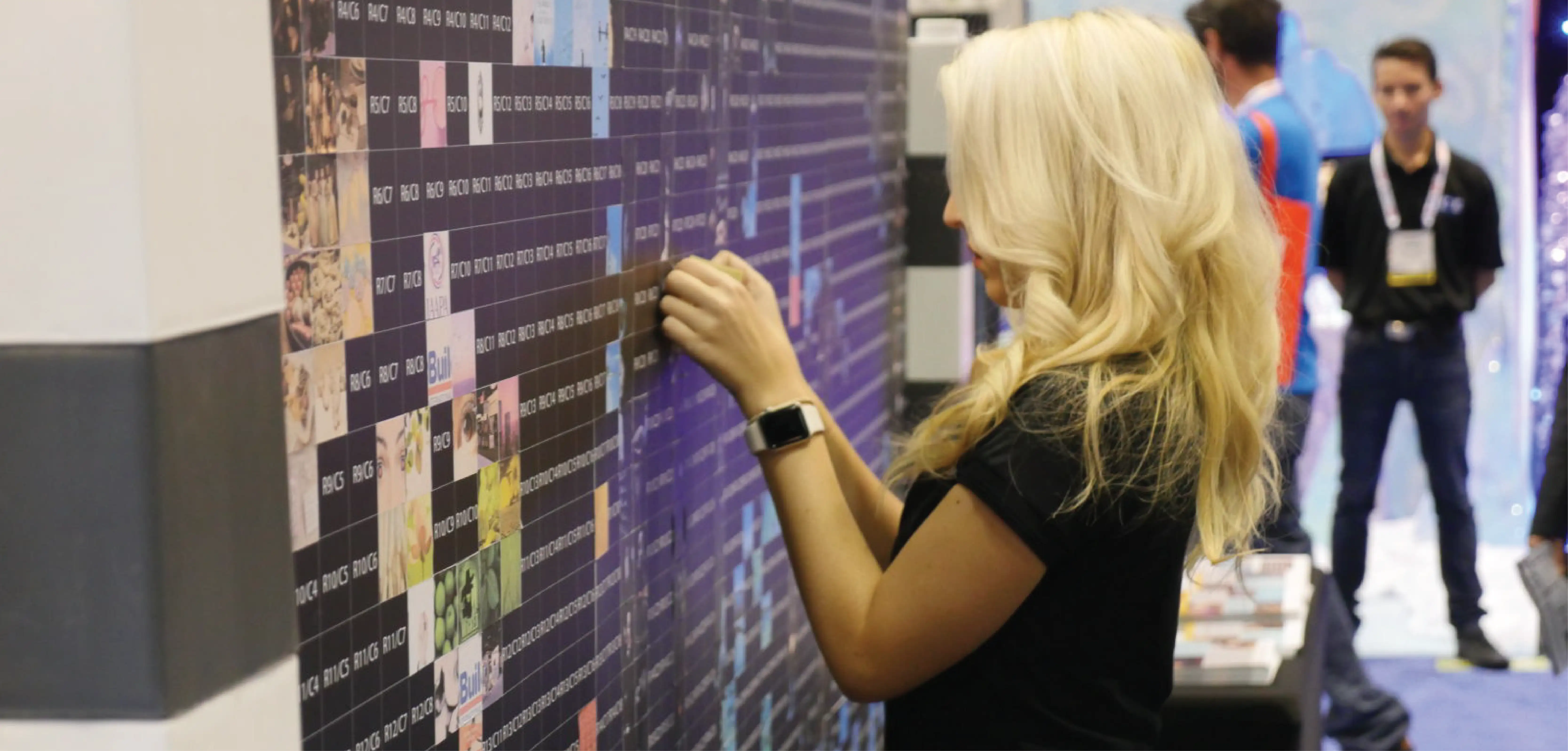 Woman pastes graphic onto interactive sign