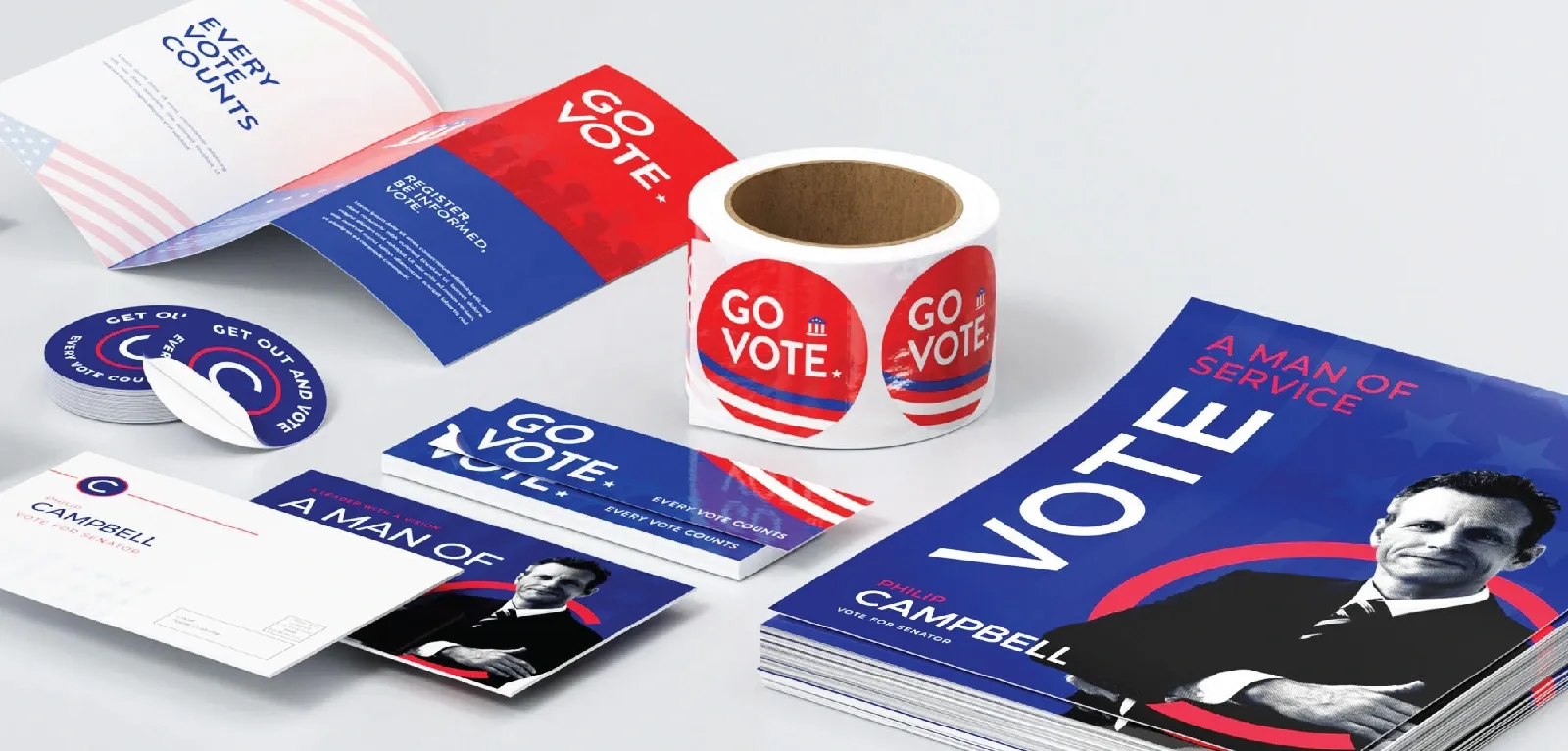 Materials including stickers, mailers. brochures, bumper stickers, and booklets in red and blue say 