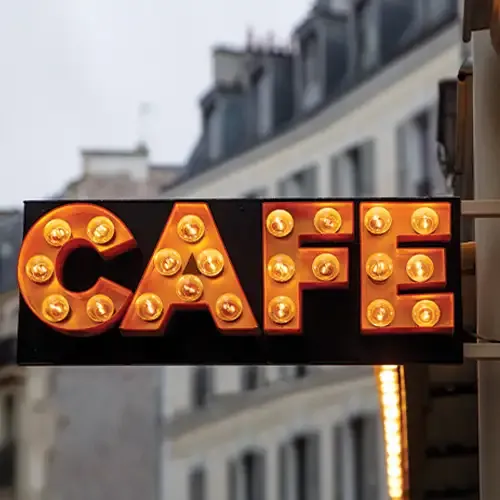 A lit up sign spells CAFE.