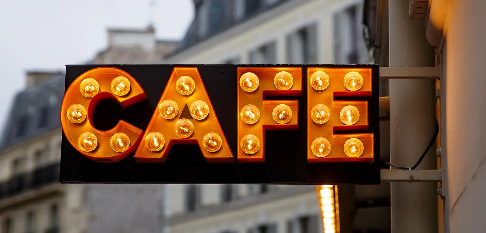 Orange, brightly-lit sign that says 