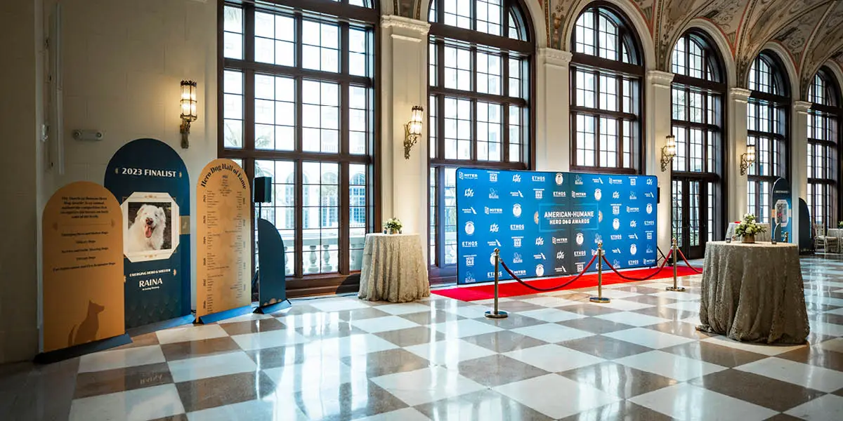 Gala with blue and yellow branded American Humane Hero Dog Awards signage