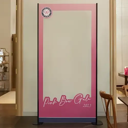 A large pink cutout resembling a Barbie Box