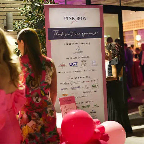 Guests stand near a sign that says 