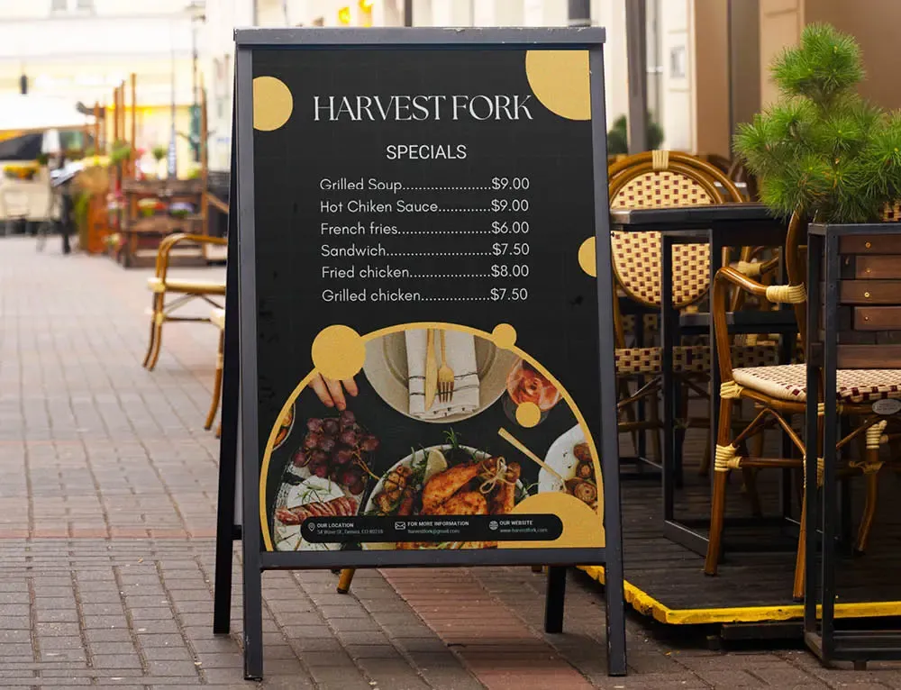 A-frame sign displays menu items outside of a restaurant on the sidewalk
